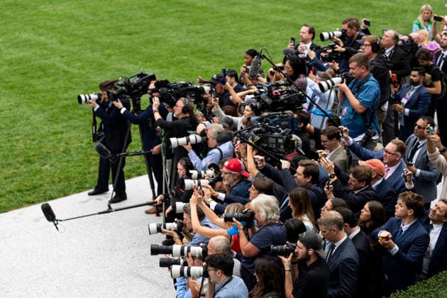 Members of the media document US President Donald Trump, not pictured, during a ribbon-cutting ceremony for the new helipad on the South Lawn of the White House in Washington, DC on Monday, September 21, 2026. The new Marine One, a Sikorsky VH-92A Patriot, has an exhaust vent that could have scorched the White House grass.  WASP20260921115 AlxDrago