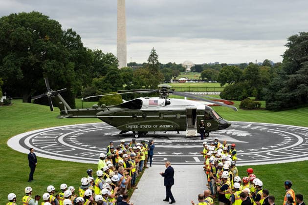President Donald Trump greets members of Clark Construction during a ribbon-cutting ceremony for the new helipad on the South Lawn of the White House in Washington, DC on Monday, September 21, 2026. The new Marine One, a Sikorsky VH-92A Patriot, has an exhaust vent that could have scorched the White House grass.  WASP20260921106 AlxDrago