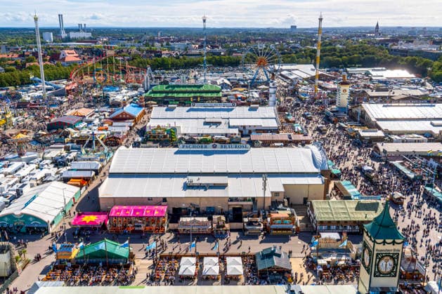 Oktoberfest 2026, panoramic view of the Wiesn with the Ferris wheel, the Hangover ride on the right, and festi