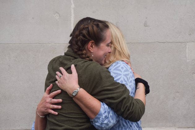 September 22, 2026, London, England, United Kingdom: The activist MICHELLE FARNHAM hugs members of her family after leaving the farrowing crate in Trafalgar Square on the final day of a protest against pig crates and factory farms organised by the animal rights group Animal Rising. The activist lived in the crate for three weeks, demonstrating how mother pigs live on factory farms, and calling for an end to farrowing crates and a pig named Luna to be freed. London United Kingdom  - ZUMAv130 20260922_zip_v130_011 Copyright: xVukxValcicx