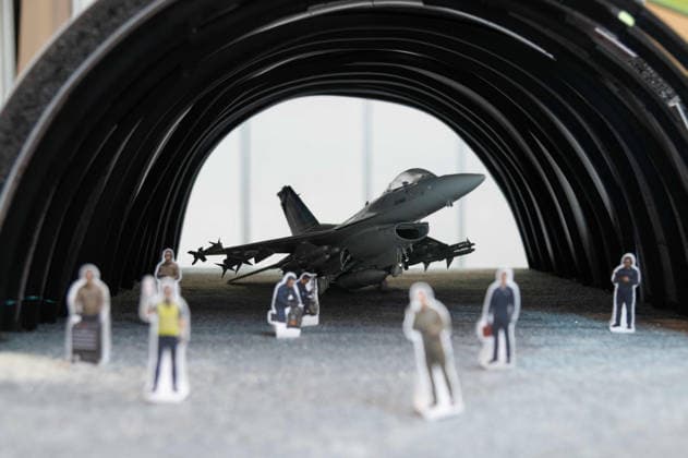 Model of an aircraft hangar with a fighter jet; the manufacturer is showcasing the equipping and retrofitting of bunker facilities here at the EUDEX Euro Defense Expo on September 22, 2026, at the Essen Exhibition Center in Germany