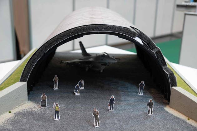Model of an aircraft hangar with a fighter jet; the manufacturer is showcasing the equipping and retrofitting of bunker facilities here at the EUDEX Euro Defense Expo on September 22, 2026, at the Essen Exhibition Center in Germany