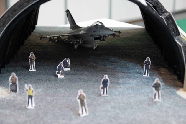 Model of an aircraft hangar with a fighter jet; the manufacturer is showcasing the equipping and retrofitting of bunker facilities here at the EUDEX Euro Defense Expo on September 22, 2026, at the Essen Exhibition Center in Germany