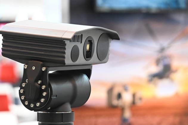 Reconnaissance system, thermal imaging camera, detectors; in the background, a poster featuring a combat helicopter; EUDEX Euro Defense Expo, September 22, 2026, at Messe Essen, Germany