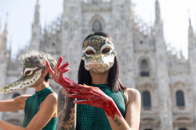 PETA’s Animal Rights Flash Mob Kicks Off Fashion Week - Milan Start of Fashion Week: a PETA animal rights flash mob featuring two women wearing crocodile masks and with their hands painted red to denounce violence against exotic animals for the production of leather shoes, belts, and handbags. Milan, Italy on September 22, 2026. Photo by fotogramma IPA ABACAPRESS.COM Milan Italy  Copyright: xFotogramma IPA ABACAx