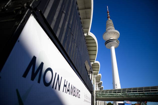 The Heinrich Hertz Tower on the grounds of the Hamburg Messe in Hamburg, Germany. A view of the Heinrich Hertz Tower between the buildings and glass facades of the Hamburg Messe during WindEnergy Hamburg. A poster reads Moin Hamburg. Hamburg, Germany 20260922_Z9A_6712