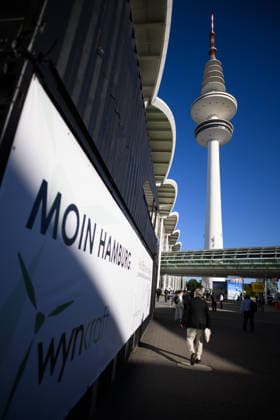 The Heinrich Hertz Tower on the grounds of the Hamburg Messe in Hamburg, Germany. A view of the Heinrich Hertz Tower between the buildings and glass facades of the Hamburg Messe during WindEnergy Hamburg. A poster reads Moin Hamburg. Hamburg, Germany 20260922_Z9A_6738
