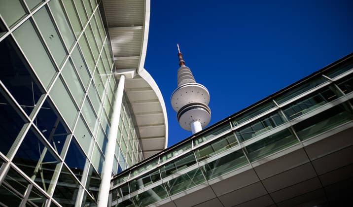 Heinrich Hertz Tower on the grounds of the Hamburg Messe in Hamburg, Germany; view of the Heinrich Hertz Tower between the buildings and glass facades of the Hamburg Messe during WindEnergy Hamburg; Hamburg, Germany 20260922_Z9A_6745