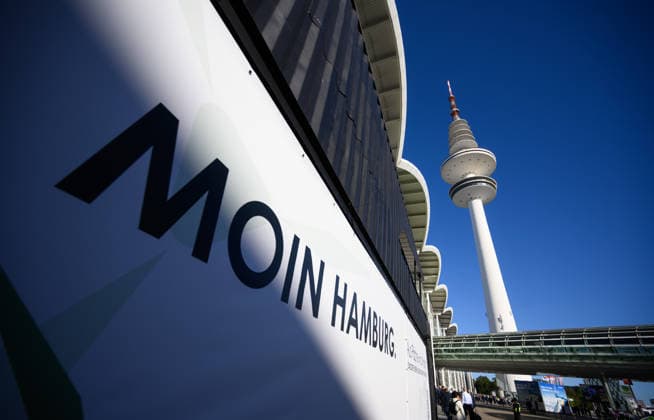 The Heinrich Hertz Tower on the grounds of the Hamburg Messe in Hamburg, Germany. A view of the Heinrich Hertz Tower between the buildings and glass facades of the Hamburg Messe during WindEnergy Hamburg. A poster reads Moin Hamburg. Hamburg, Germany 20260922_Z9B_6879