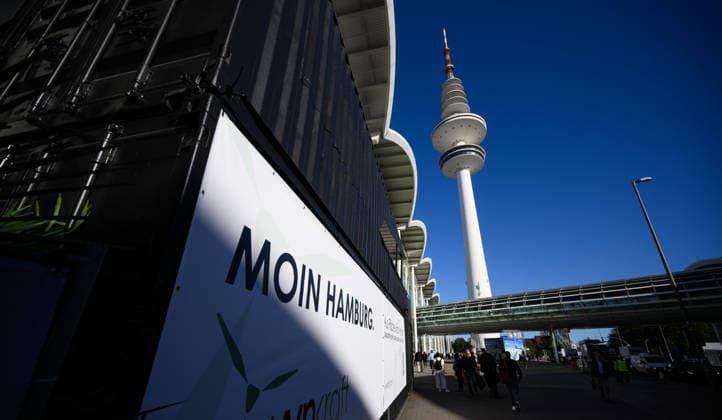 The Heinrich Hertz Tower on the grounds of the Hamburg Messe in Hamburg, Germany. A view of the Heinrich Hertz Tower between the buildings and glass facades of the Hamburg Messe during WindEnergy Hamburg. A poster reads Moin Hamburg. Hamburg, Germany 20260922_Z9B_6886