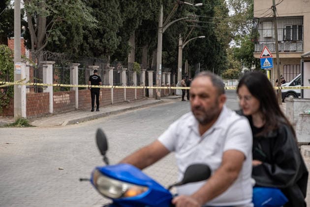 September 22, 2026, Manisa, Turkey: A couple on a motorcycle rides past a Do Not Enter police tape. Police maintained security measures around a high school in Turgutlu, in Turkey™s western Manisa province, following a shooting that left 11 people injured. The Turkish Interior Minister and Education Minister addressed the media following the incident. Manisa Turkey - ZUMAs197 20260922_aaa_s197_458 Copyright: xMuratxKocabasx