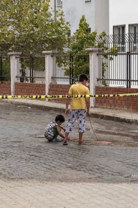 September 22, 2026, Manisa, Turkey: Children play in front of police crime scene tape. Police maintained security measures around a high school in Turgutlu, in Turkey™s western Manisa province, following a shooting that left 11 people injured. The Turkish Interior Minister and Education Minister addressed the media following the incident. Manisa Turkey - ZUMAs197 20260922_aaa_s197_469 Copyright: xMuratxKocabasx