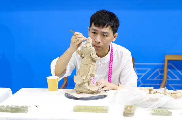 (260923) -- SHANGHAI, Sept. 23, 2026 -- A ceramic art master demonstrates the craftsmanship of Dehua porcelain during the WorldSkills Shanghai 2026 Expo in east China s Shanghai, Sept. 23, 2026. The expo kicked off here on Wednesday. ) CHINA-SHANGHAI-WORLDSKILLS SHANGHAI 2026 EXPO (CN) WangxJingqiang 