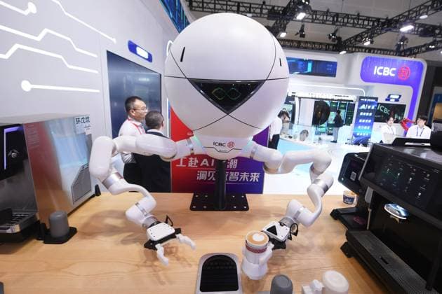 HANGZHOU, CHINA - SEPTEMBER 23: A humanoid robot makes coffee for visitors during the 5th Global Digital Trade Expo on September 23, 2026 in Hangzhou, Zhejiang Province of China. The expo focuses on frontier AI technologies and digital trade development.  Copyright: xVCGx 111669003022
