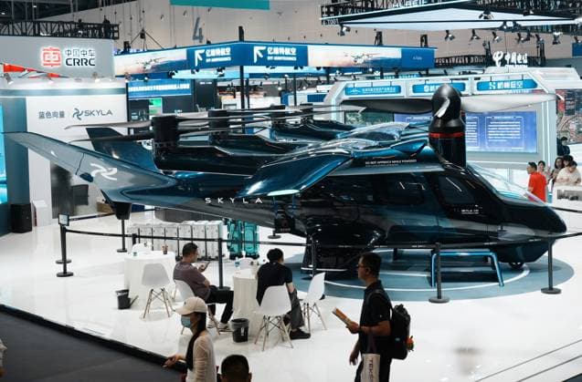 HANGZHOU, CHINA - SEPTEMBER 23: Visitors view a six-seat tilt-rotor electric vertical takeoff and landing (eVTOL) aircraft at the fifth Global Digital Trade Expo on September 23, 2026 in Hangzhou, Zhejiang Province of China. The expo focuses on frontier artificial intelligence technologies.  Copyright: xVCGx 111669003012