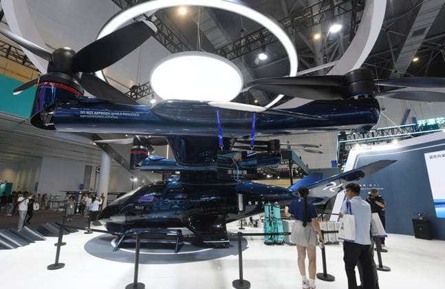 HANGZHOU, CHINA - SEPTEMBER 23: Visitors view a six-seat tilt-rotor electric vertical takeoff and landing (eVTOL) aircraft at the fifth Global Digital Trade Expo on September 23, 2026 in Hangzhou, Zhejiang Province of China. The expo focuses on frontier artificial intelligence technologies and digital trade.  Copyright: xVCGx 111669003003