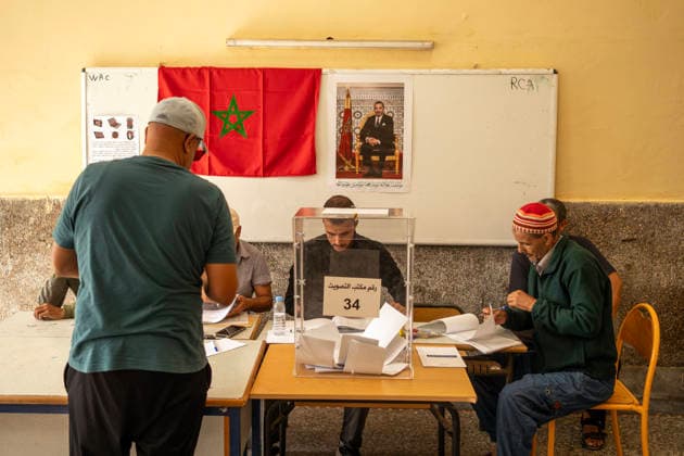 September 23, 2026, Essaouira, Morocco: Officials sit at a registration table beneath a Moroccan flag during parliamentary elections in Essaouira, Morocco. Essaouira Morocco  - ZUMAz174 20260923_zip_z174_007 Copyright: xMoexZoyarix