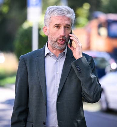 Tübingen, September 23, 2026: Mayor Boris Palmer, an independent, on his cell phone during a visit to the company BLUEmobility