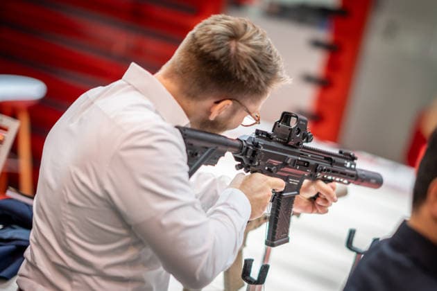 A view of the exhibition halls and the fairgrounds; the Heckler & Koch booth featuring handguns and machine guns; the Euro Defence Expo 2026 defense trade show in Essen, Germany; Essen, North Rhine-Westphalia, Germany; the fairgrounds