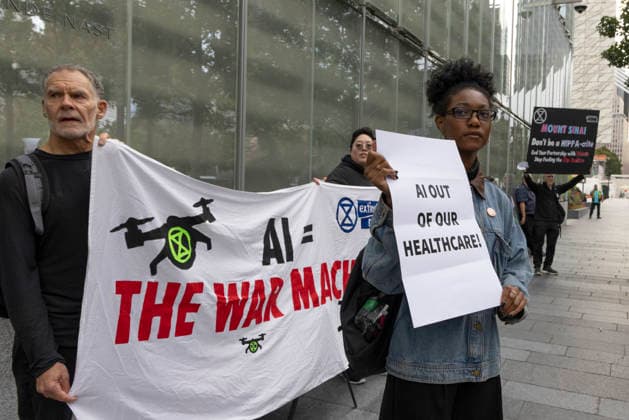 September 23, 2026, New York, New York, USA: ACT UP NY leads a coalition of organizations blockading the entrance to 1 WTC and later blocking traffic on the West Side Highway demonstrating under the banner AI OUT OF OUR HEALTHCARE! PALANTIR OUT OF MOUNT SINAI! as the Newsweek AI Health Summit is held inside the building and a keynote speaker is Dr. Brendan Carr, (not pictured) CEO of Mount Sinai. Approximately 20 protesters are arrested by NYPD. Part of the MONEY FOR AIDS and HEALTHCARE! NOT FOR ICE and WARFARE! ACT UP (AIDS Coalition To Unleash Power) campaign, demonstrators denounce Mount Sinai s contract with Palantir, a surveillance, data analytics and military tech company. Protesters chant and hold banners and signs that read AI eq  - ZUMAr174 20260923_znp_r174_004 Copyright: xGinaxMxRandazzox