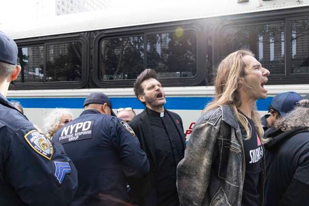 September 23, 2026, New York, New York, USA: ACT UP leads a coalition of organizations blockading the entrance to 1 WTC and later blocking traffic on the West Side Highway demonstrating under the banner AI OUT OF OUR HEALTHCARE! PALANTIR OUT OF MOUNT SINAI! as the Newsweek AI Health Summit is held inside the building and a keynote speaker is Dr. Brendan Carr, (not pictured) CEO of Mount Sinai. Arrestees chant as they are taken to a police bus after approximately 20 protesters are arrested by NYPD. Part of the MONEY FOR AIDS and HEALTHCARE! NOT FOR ICE and WARFARE! ACT UP (AIDS Coalition To Unleash Power) campaign, demonstrators denounce Mount Sinai s contract with Palantir, a surveillance, data analytics and military tech company. New Yo - ZUMAr174 20260923_znp_r174_049 Copyright: xGinaxMxRandazzox