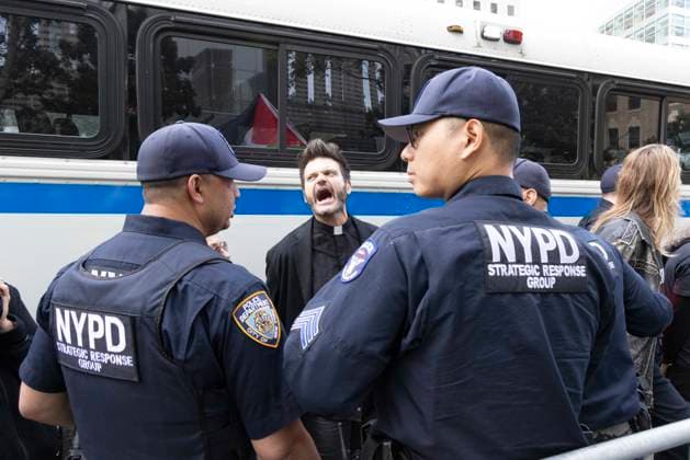 September 23, 2026, New York, New York, USA: ACT UP leads a coalition of organizations blockading the entrance to 1 WTC and later blocking traffic on the West Side Highway demonstrating under the banner AI OUT OF OUR HEALTHCARE! PALANTIR OUT OF MOUNT SINAI! as the Newsweek AI Health Summit is held inside the building and a keynote speaker is Dr. Brendan Carr, (not pictured) CEO of Mount Sinai. Arrestees are taken to a police bus after approximately 20 protesters are arrested by NYPD. Part of the MONEY FOR AIDS and HEALTHCARE! NOT FOR ICE and WARFARE! ACT UP (AIDS Coalition To Unleash Power) campaign, demonstrators denounce Mount Sinai s contract with Palantir, a surveillance, data analytics and military tech company. New York USA - ZUMAr174 20260923_znp_r174_050 Copyright: xGinaxMxRandazzox