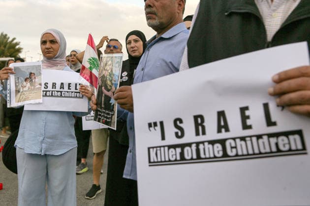 September 23, 2026, Beirut, Beirut, Lebanon: A Lebanese mother holds a banner accusing Israel of killing children along pictures of her children who died in war between Israel and pro-Iranian Hezbollah war during a candle vigil ceremony in Beirut. Lebanese lawmaker Inaya Ezzeddine, who chairs the Lebanese parliamentÃ¢â‚¬â ¢s Women and Children Committee, said Ã¢â‚¬oenearly 800 children were killed during the two Israeli wars in 2024 and 2026Ã¢â‚¬Â, and around 360,000 displaced. Beirut Lebanon  - ZUMAn313 20260923_zip_n313_008 Copyright: xMarwanxNaamanix