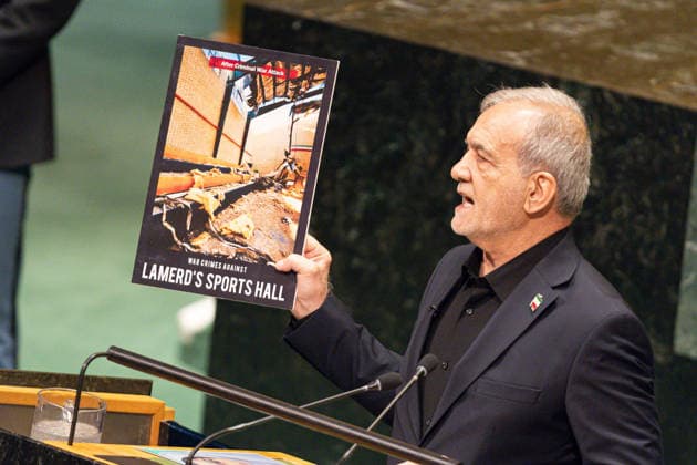 September 23, 2026, New York City, USA: Iranian President Masoud Pezeshkian holds up a photograph showing the aftermath of what is described on the poster as a criminal war attack and war crimes against Lamerd s Sports Hall during his address on the second day of the General Debate of the 81st session of the United Nations General Assembly at the UN Headquarters in New York City. New York USA  - ZUMAl194 20260923_zip_l194_028 Copyright: xMarekxLadzinskix