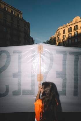 September 23, 2026, Barcelona, Catalonia, Spain: September 23, 2026, Barcelona, Spain: A protester holds up a banner, seen from behind against the evening light. Hundreds of people gathered in front of the Spanish Government Delegation in Catalonia, on Mallorca Street in Barcelona, at a protest against evictions called by tenants and housing unions, including the Sindicat de Llogateres, the Barcelona Tenants Union. The protest followed the eviction that morning in Madrid of MARICARMEN, an 87-year-old woman forced out of the rented flat where she had lived for seventy years, and the death of OLGA, a woman from L Hospitalet de Llobregat who took her own life after being evicted. The unions warned that they will call a general strike if the  - ZUMAs392 20260923_zip_s392_005 Copyright: xFabianxSuspensivox
