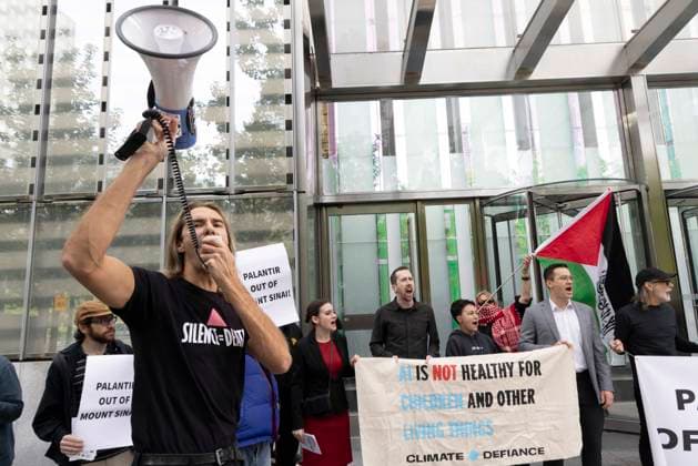 September 23, 2026, New York, New York, USA: ACT UP NY leads a coalition of organizations blockading the entrance to 1 WTC and later blocking traffic on the West Side Highway demonstrating under the banner AI OUT OF OUR HEALTHCARE! PALANTIR OUT OF MOUNT SINAI! as the Newsweek AI Health Summit is held inside the building and a keynote speaker is Dr. Brendan Carr, (not pictured) CEO of Mount Sinai. Approximately 20 protesters are arrested by NYPD. Part of the MONEY FOR AIDS and HEALTHCARE! NOT FOR ICE and WARFARE! ACT UP (AIDS Coalition To Unleash Power) campaign, demonstrators denounce Mount Sinai s contract with Palantir, a surveillance, data analytics and military tech company. Protesters chant and hold banners and signs that read AI IS - ZUMAr174 20260923_znp_r174_002 Copyright: xGinaxMxRandazzox