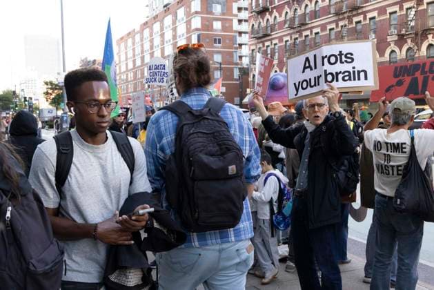 September 23, 2026, New York, New York, USA: Protesters hold signs reading AI rots your brain as pedestrians pass and employees exit Goggle s offices in ManhattanÃ¢â‚¬â ¢s Chelsea neighborhood at the end of their workday. A coalition of climate groups hold a family friendly singing demonstration protesting Google for embedding AI in educational tools and building gas powered data centers fueling the climate crisis. The event is part of the Unplug AI Week of Action during Climate Week NYC. Organizers call for a pause on advanced AI development and data center expansion and a national moratorium on the use of AI in schools. New York USA  - ZUMAr174 20260923_znp_r174_064 Copyright: xGinaxMxRandazzox