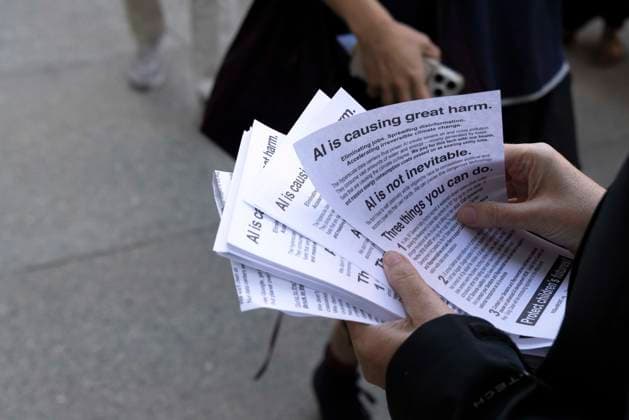September 23, 2026, New York, New York, USA: A person hands out leaflets to Google employees as they exit at the end of their workday that read AI is causing great harm. AI is not inevitable. Three things you can do. A coalition of climate groups hold a family friendly singing demonstration outside GoogleÃ¢â‚¬â ¢s offices in ManhattanÃ¢â‚¬â ¢s Chelsea neighborhood protesting Google for embedding AI in educational tools and building gas powered data centers fueling the climate crisis. The event is part of the Unplug AI Week of Action during Climate Week NYC. Organizers call for a pause on advanced AI development and data center expansion and a national moratorium on the use of AI in schools. New York USA  - ZUMAr174 20260923_znp_r174_065 Copyright: xGinaxMxRandazzox
