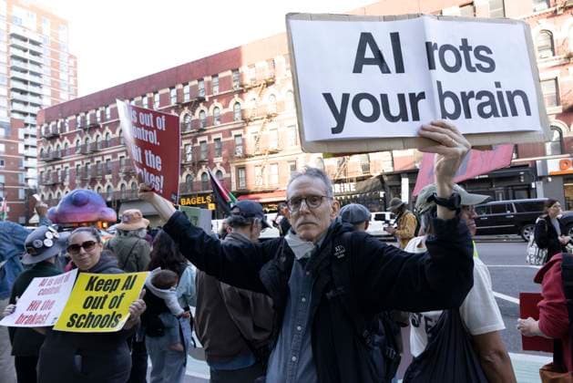 September 23, 2026, New York, New York, USA: Protesters hold signs reading AI rots your brain Keep AI out of schools AI is out of control. Hit the brakes! as employees exit Goggle s offices in ManhattanÃ¢â‚¬â ¢s Chelsea neighborhood at the end of their workday. A coalition of climate groups hold a family friendly singing demonstration protesting Google for embedding AI in educational tools and building gas powered data centers fueling the climate crisis. The event is part of the Unplug AI Week of Action during Climate Week NYC. Organizers call for a pause on advanced AI development and data center expansion and a national moratorium on the use of AI in schools. New York USA  - ZUMAr174 20260923_znp_r174_069 Copyright: xGinaxMxRandazzox