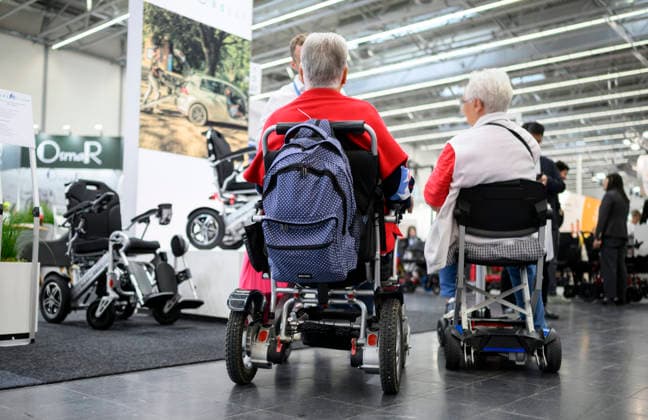 Visitors in wheelchairs gather information at REHACARE, the trade fair for rehabilitation and care, September 23–26, 2026, in Düsseldorf, Germany