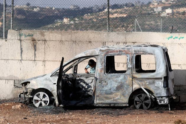 Israeli settlers set fire to Palestinian cars in attack on Atara town near Ramallah RAMALLAH, WEST BANK, PALESTINE - SEPTEMBER 24: Palestinian children stand on and play inside the charred remains of burned vehicles following an attack by Israeli settlers in the town of Atara, north of Ramallah in West Bank, Palestine on September 24, 2026. Israeli settlers raided the town and set fire to two cars belonging to local Palestinians, leaving them completely destroyed. Issam Rimawi Anadolu Ramallah West Bank. Editorial use only. Please get in touch for any other usage.  Copyright: x2026xAnadoluxIssamxRimawix