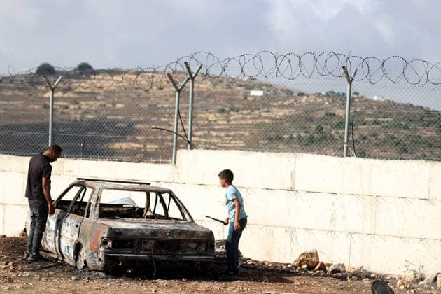 Israeli settlers set fire to Palestinian cars in attack on Atara town near Ramallah RAMALLAH, WEST BANK, PALESTINE - SEPTEMBER 24: Palestinian children stand on and play inside the charred remains of burned vehicles following an attack by Israeli settlers in the town of Atara, north of Ramallah in West Bank, Palestine on September 24, 2026. Israeli settlers raided the town and set fire to two cars belonging to local Palestinians, leaving them completely destroyed. Issam Rimawi Anadolu Ramallah West Bank. Editorial use only. Please get in touch for any other usage.  Copyright: x2026xAnadoluxIssamxRimawix