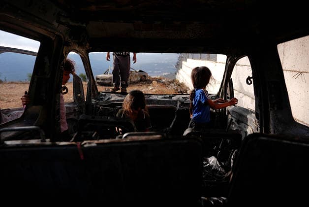 Israeli settlers set fire to Palestinian cars in attack on Atara town near Ramallah RAMALLAH, WEST BANK, PALESTINE - SEPTEMBER 24: Palestinian children stand on and play inside the charred remains of burned vehicles following an attack by Israeli settlers in the town of Atara, north of Ramallah in West Bank, Palestine on September 24, 2026. Israeli settlers raided the town and set fire to two cars belonging to local Palestinians, leaving them completely destroyed. Issam Rimawi Anadolu Ramallah West Bank. Editorial use only. Please get in touch for any other usage.  Copyright: x2026xAnadoluxIssamxRimawix