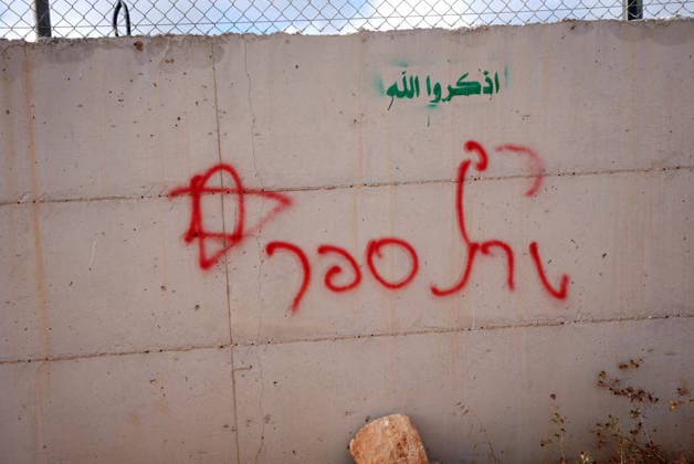 Israeli settlers set fire to Palestinian cars in attack on Atara town near Ramallah RAMALLAH, WEST BANK, PALESTINE - SEPTEMBER 24: Racist graffiti are seen following an attack by Israeli settlers in the town of Atara, north of Ramallah in West Bank, Palestine on September 24, 2026. Israeli settlers raided the town and set fire to two cars belonging to local Palestinians, leaving them completely destroyed. Issam Rimawi Anadolu Ramallah West Bank. Editorial use only. Please get in touch for any other usage.  Copyright: x2026xAnadoluxIssamxRimawix
