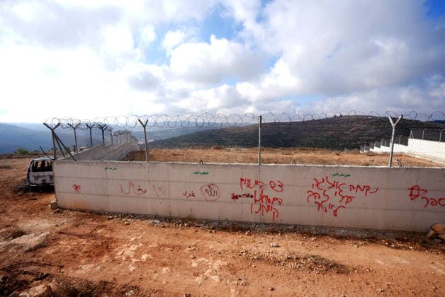 Israeli settlers set fire to Palestinian cars in attack on Atara town near Ramallah RAMALLAH, WEST BANK, PALESTINE - SEPTEMBER 24: Burnt vehicles and racist graffiti are seen following an attack by Israeli settlers in the town of Atara, north of Ramallah in West Bank, Palestine on September 24, 2026. Israeli settlers raided the town and set fire to two cars belonging to local Palestinians, leaving them completely destroyed. Issam Rimawi Anadolu Ramallah West Bank. Editorial use only. Please get in touch for any other usage.  Copyright: x2026xAnadoluxIssamxRimawix
