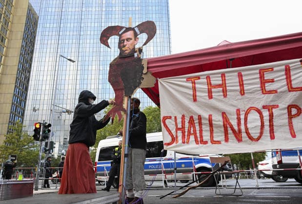 Protest held against Peter Thiel receiving 2026 Axel Springer Award BERLIN, GERMANY - SEPTEMBER 24: Protesters gather near the Axel Springer building, against US investor and Palantir co-founder Peter Thiel receiving the 2026 Axel Springer Award. Demonstrators criticize Thiel and Palantir s activities and carry various banners and placards, in Berlin, capital of Germany, on September 24, 2026. Halil Sagirkaya Anadolu Berlin Germany. Editorial use only. Please get in touch for any other usage.  Copyright: x2026xAnadoluxHalilxSagirkayax
