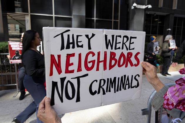 September 24, 2026, New York, New York, USA: A protester holds a sign that reads THEY WERE NEIGHBORS NOT CRIMINALS at Rise and Resist s weekly vigil for those impacted by President Trump s immigrant detention and mass deportation policies, held outside the immigration courts, Department of Homeland Security and ICE offices at 26 Federal Plaza in Lower Manhattan. New York USA  - ZUMAr174 20260924_znp_r174_013 Copyright: xGinaxMxRandazzox