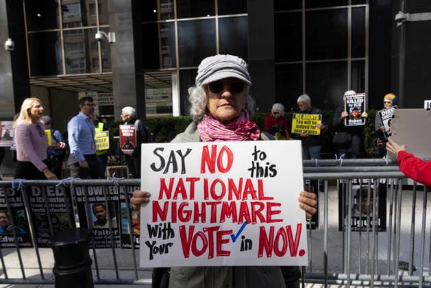 September 24, 2026, New York, New York, USA: A protester holds a sign that reads SAY NO to this NATIONAL NIGHTMARE With Your VOTE in NOV. at Rise and Resist s weekly vigil for those impacted by President Trump s immigrant detention and mass deportation policies, held outside the immigration courts, Department of Homeland Security and ICE offices at 26 Federal Plaza in Lower Manhattan. New York USA  - ZUMAr174 20260924_znp_r174_022 Copyright: xGinaxMxRandazzox
