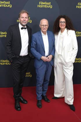 Helge Albers, Peter Tschentscher, and Malika Rabahallah at the festival opening, featuring the premiere of the film *The Idiots* at the 34th Filmfest Hamburg 2026 at Cinemaxx Dammtor in Hamburg, September 24, 2026 Foto:xgbrcix xFuturexImagex filmfest_hh_6784