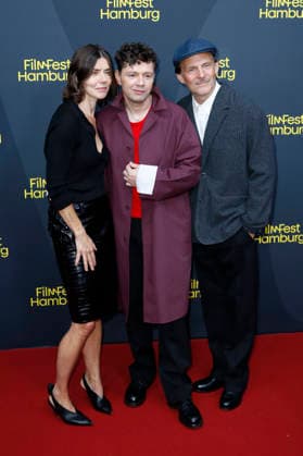 Malgorzata Szumowska, Christian Friedel, and Michal Englert at the festival opening, featuring the premiere of the feature film *The Idiots* at the 34th Filmfest Hamburg 2026 at Cinemaxx Dammtor in Hamburg, September 24, 2026 Foto:xC.xTamckex xFuturexImagex filmfest_hh_6943