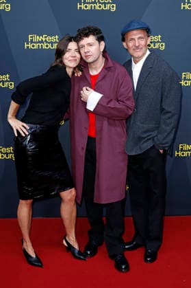 Malgorzata Szumowska, Christian Friedel, and Michal Englert at the festival opening, featuring the premiere of the feature film *The Idiots* at the 34th Filmfest Hamburg 2026 at Cinemaxx Dammtor in Hamburg, September 24, 2026 Foto:xC.xTamckex xFuturexImagex filmfest_hh_6946