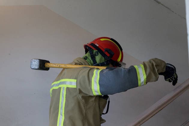 A firefighter carries a hammer on his shoulder during a response effort in an apartment block in the Pechersk district, struck by a Russian drone strike, Kyiv, Ukraine, September 25, 2026. A 14-year-old boy was killed, and at least seven people were injured in the attack. (Photo by Kyrylo Chubotin Ukrinform) Russian drone hits apartment block in central Kyiv  Copyright: xKirillxChubotinx