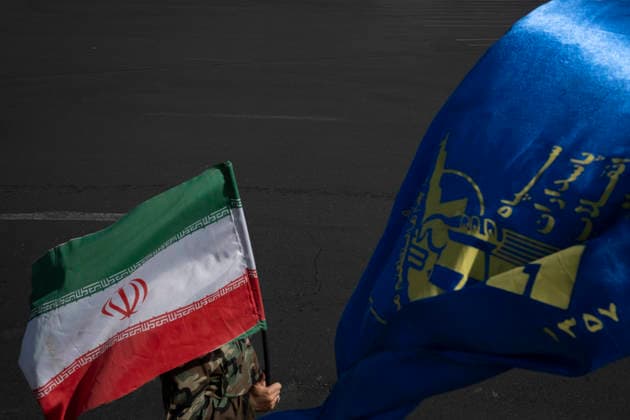 A Rally Of Motorcyclists From Iran™s Self-Sacrificing Forces An unidentified man wearing an Islamic Revolutionary Guard Corps (IRGC) uniform carries an Iranian national flag as he walks past an IRGC flag during a rally of motorcyclists from Iran s Self-Sacrificing Forces in Tehran, Iran, on September 25, 2026, amid escalating tensions between Iran and the United States. Tehran Tehran Iran  Copyright: xMortezaxNikoubazlx originalFilename: nikoubazl-arallyof260925_np5fh.jpg