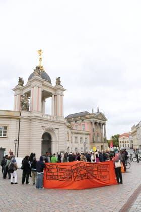 Protesters stand outside the state parliament holding banners reading No one is illegal, Personne n’est clandestine, Kein Mensch ist illegal, Hiçbir insan illegal degildir, and Ninguna persona es ilegal during a demonstration against the prepaid card for refugees in Brandenburg, Potsdam, September 25, 2026. Protest against the prepaid card in Potsdam