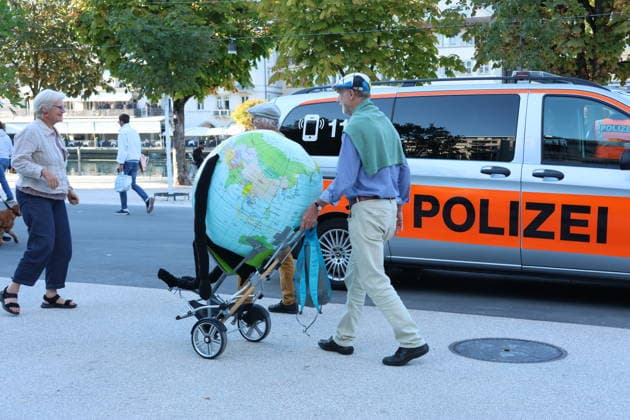 September 25, 2026, City of Lucerne: Demonstration, climate rally in Lucerne against climate change, under the slogan No 50-Degree Summers ; photo of demonstrators with a globe