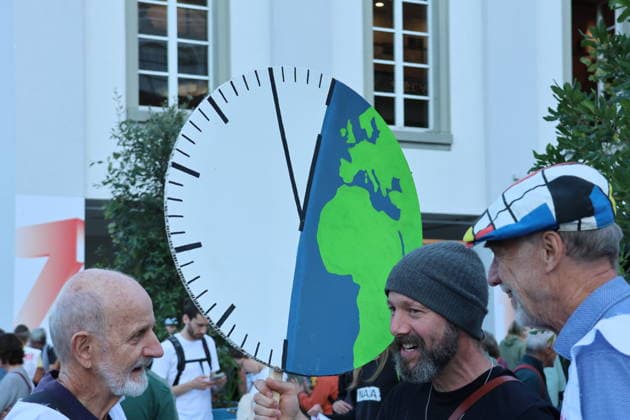 September 25, 2026, City of Lucerne: Demonstration, climate rally in Lucerne against climate change, under the slogan No 50-degree summers. Photo: Demonstrators—it’s five to twelve.